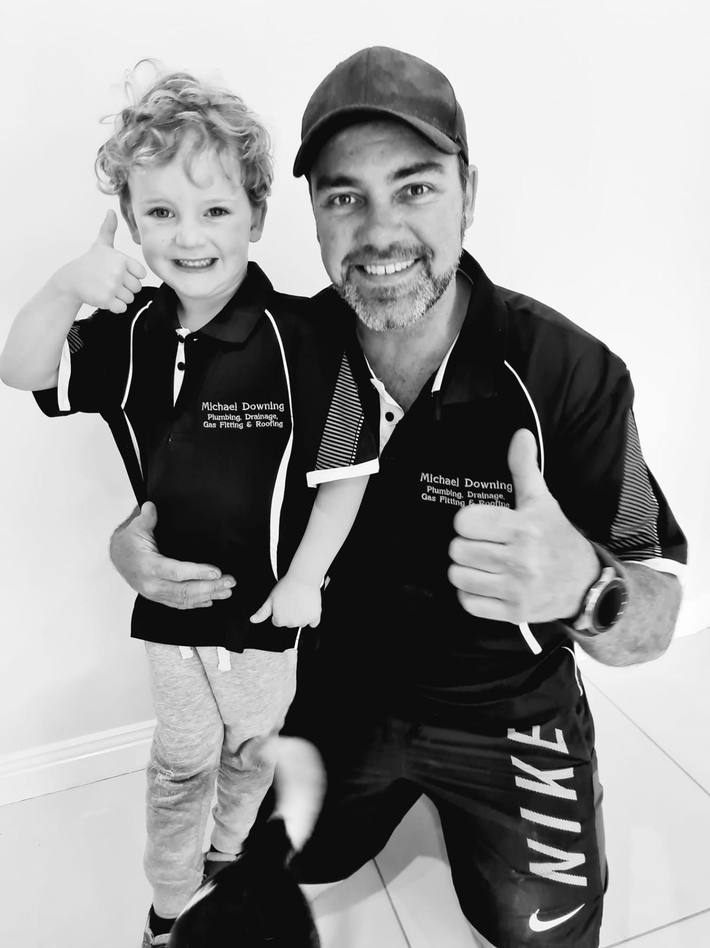 Michael Downing with his son wearing matching work shirts